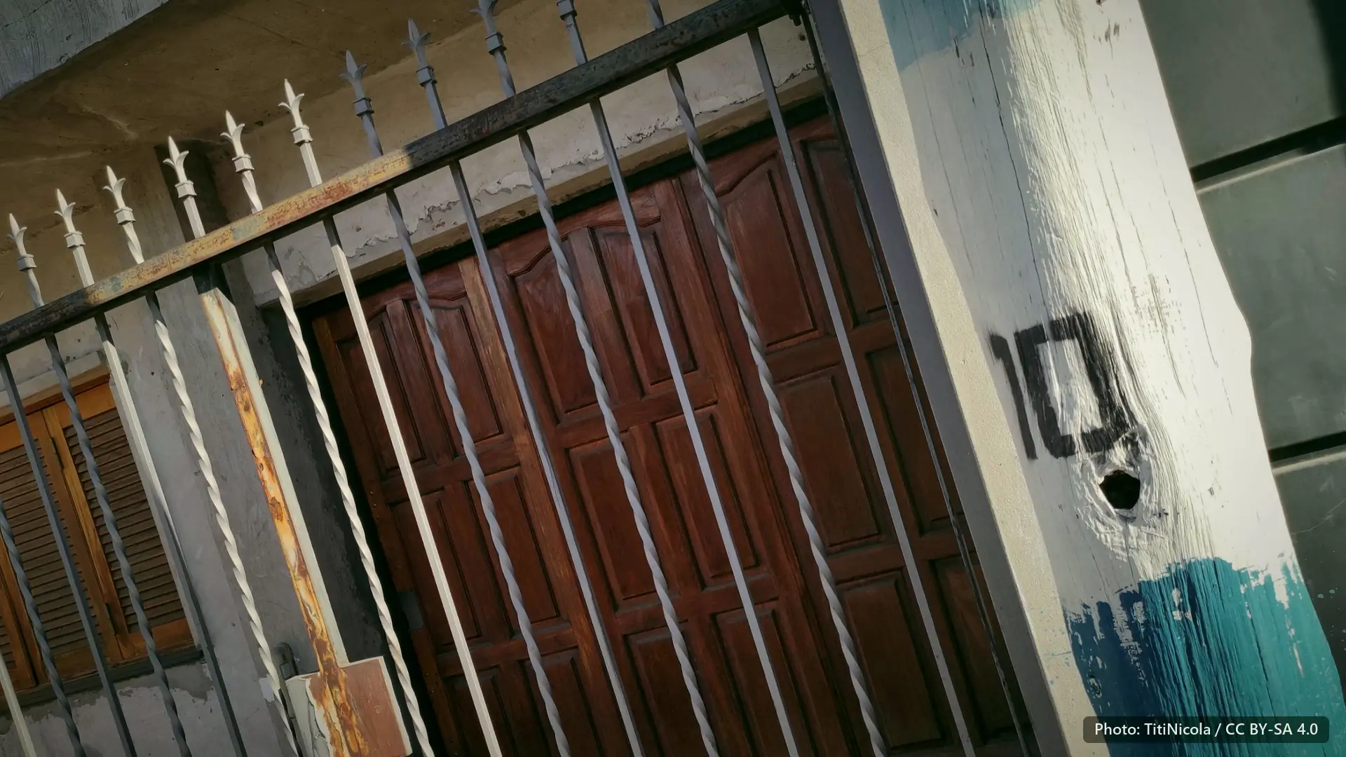 An iron gate and a painted post.